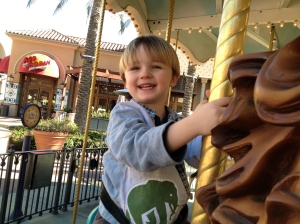 Riding the carousel during an outing with Aunt Jacki.